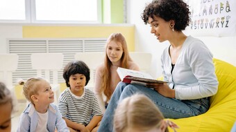 Professeur assise devant ses éléèves